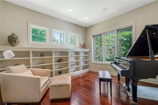 living area with baseboards, wood-type flooring, and recessed lighting