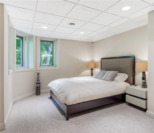 bedroom with visible vents, baseboards, a drop ceiling, light colored carpet, and recessed lighting