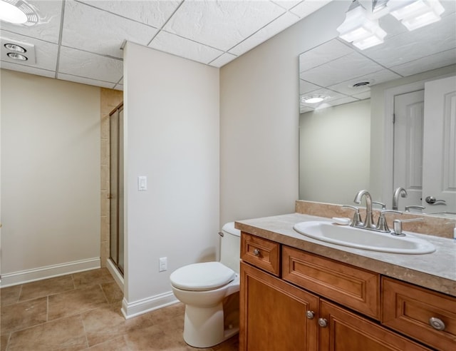 bathroom with toilet, a shower stall, baseboards, and vanity