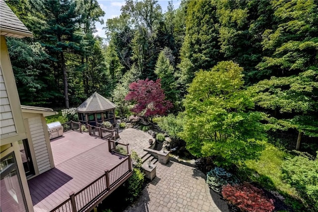 wooden terrace with a patio area and a wooded view