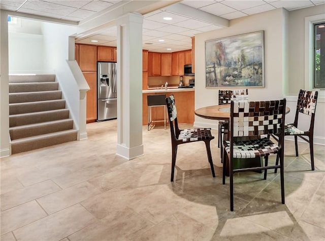 dining space with baseboards, stairway, a drop ceiling, and recessed lighting