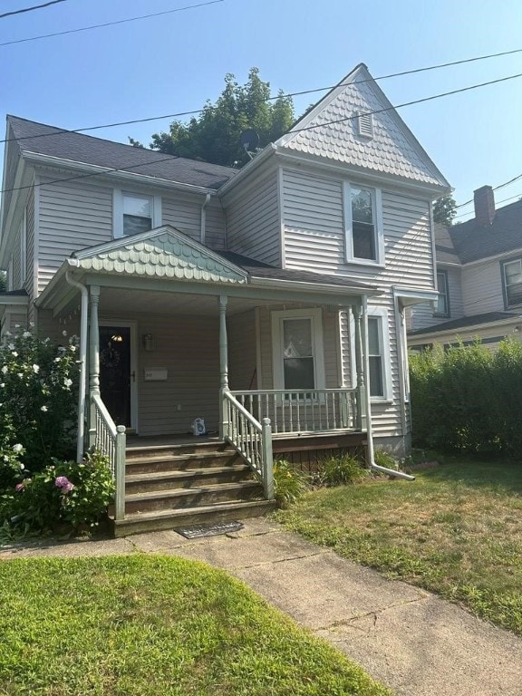 victorian-style house with covered porch and a front yard