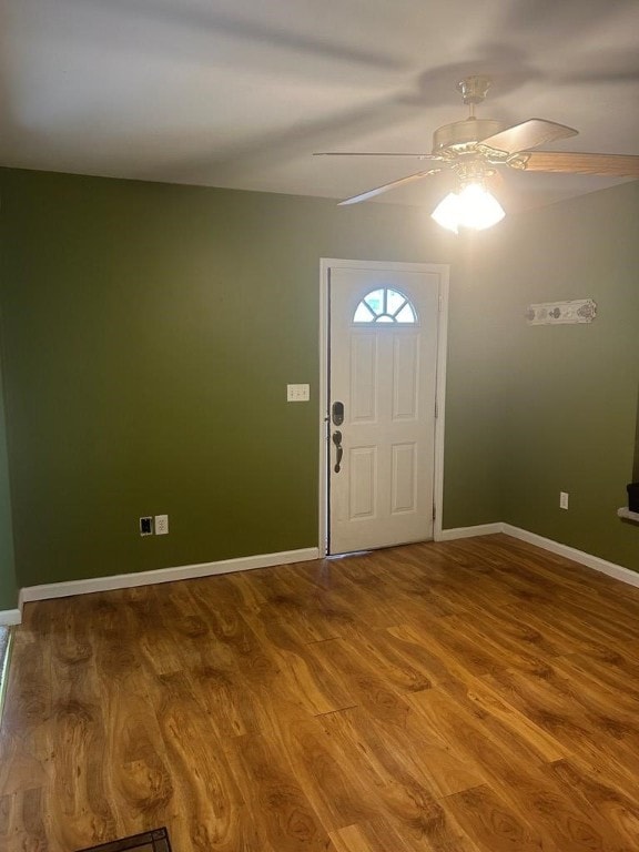 entrance foyer with ceiling fan, wood finished floors, and baseboards