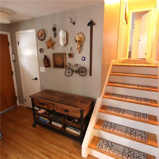 stairway with wood finished floors