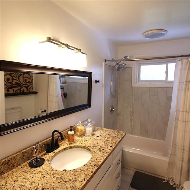 full bath with shower / bath combo, vanity, and toilet