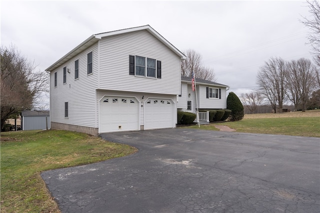 split level home featuring aphalt driveway, a garage, and a front lawn