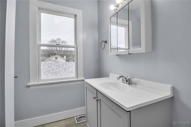 192 Cottage St, Lockport-City, NY 14094 - bathroom featuring visible vents, plenty of natural light, vanity, and baseboards