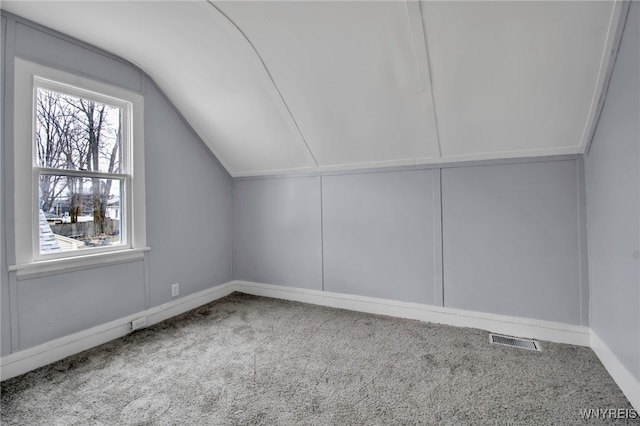 192 Cottage St, Lockport-City, NY 14094 - additional living space with visible vents, vaulted ceiling, and carpet flooring