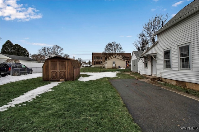 192 Cottage St, Lockport-City, NY 14094 - view of yard featuring entry steps, aphalt driveway, fence, a storage unit, and an outdoor structure