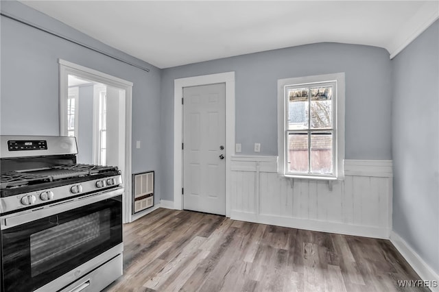 192 Cottage St, Lockport-City, NY 14094 - kitchen featuring wainscoting, vaulted ceiling, stainless steel gas range oven, and wood finished floors