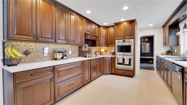 kitchen with recessed lighting, light countertops, decorative backsplash, stainless steel double oven, and dishwashing machine