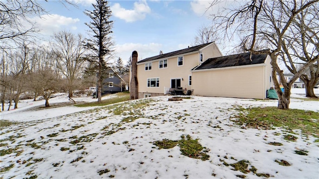 snow covered house with a chimney