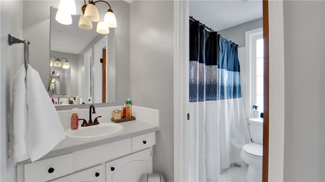 bathroom featuring a chandelier, a shower with shower curtain, vanity, and toilet