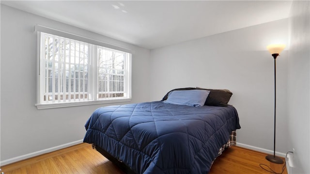 bedroom featuring wood finished floors and baseboards