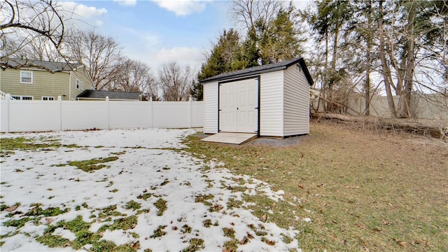 exterior space featuring a fenced backyard, a storage unit, and an outdoor structure