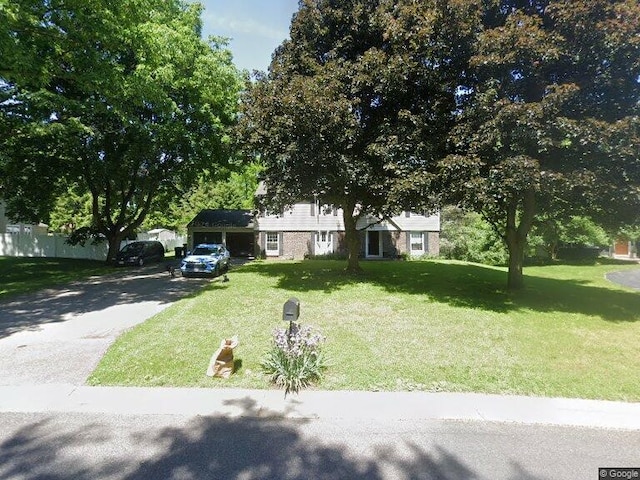 split level home featuring aphalt driveway and a front yard