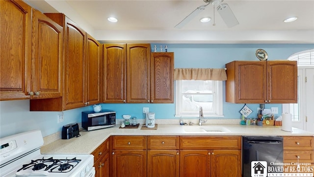 kitchen with white range with gas stovetop, a sink, a wealth of natural light, dishwasher, and stainless steel microwave