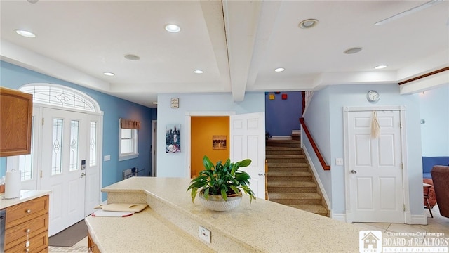 interior space with baseboards, dishwashing machine, light countertops, beam ceiling, and recessed lighting