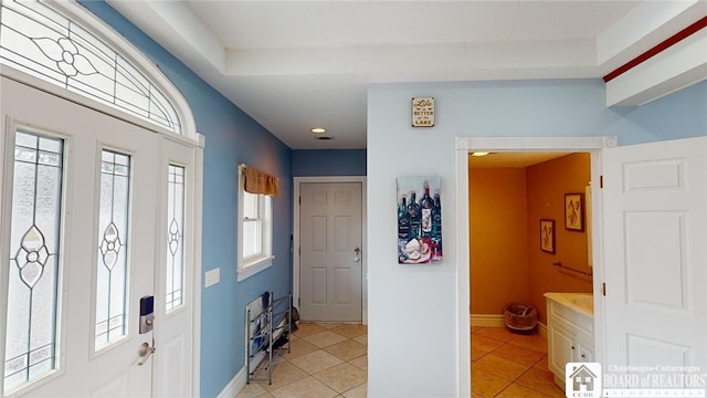 foyer with baseboards and light tile patterned floors