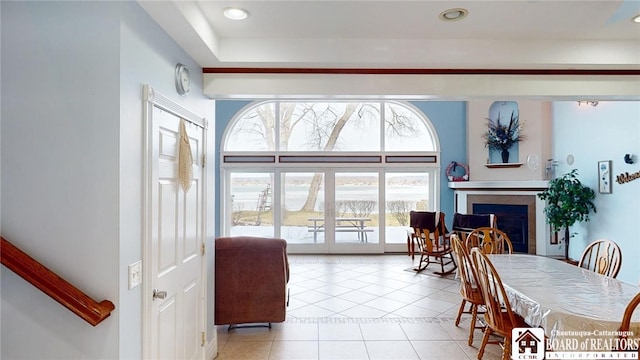 dining room featuring tile patterned flooring, a fireplace, and recessed lighting