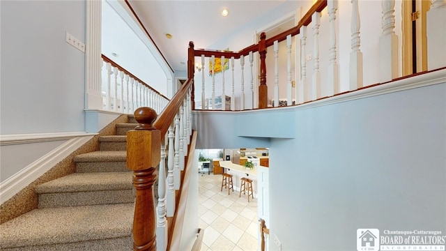 staircase with tile patterned flooring and recessed lighting