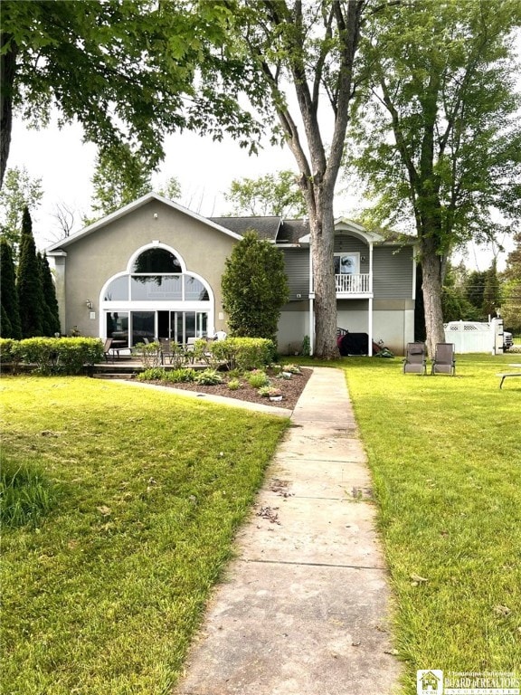 view of front of property with a front yard and stucco siding