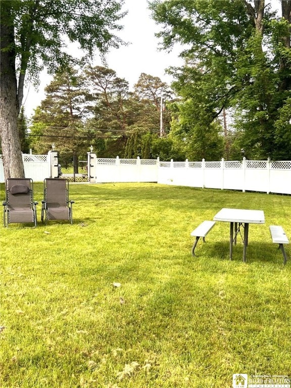 surrounding community featuring a lawn and fence