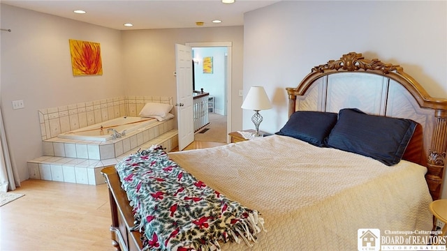 bedroom featuring wood finished floors and recessed lighting