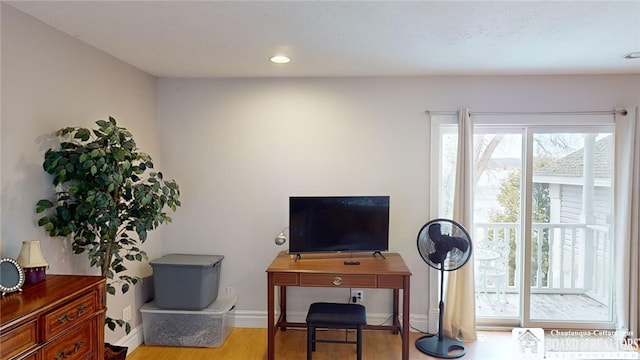 office space with recessed lighting, wood finished floors, and baseboards