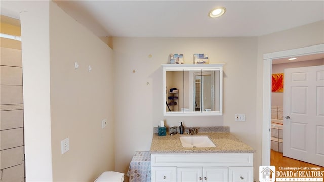 bathroom featuring recessed lighting, vanity, and toilet