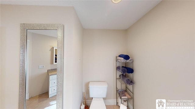 interior space featuring vanity, tile patterned flooring, and toilet