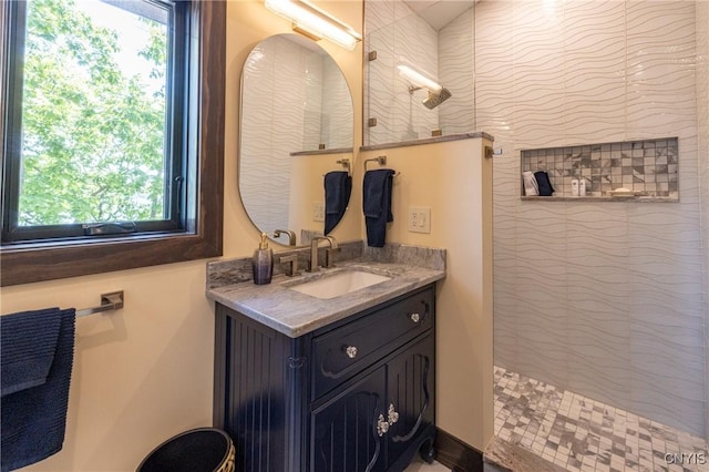 full bath featuring vanity and a walk in shower