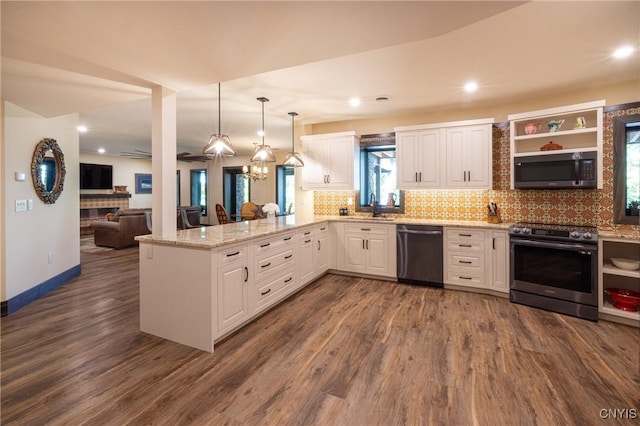 kitchen featuring stainless steel appliances, a peninsula, white cabinetry, and decorative backsplash