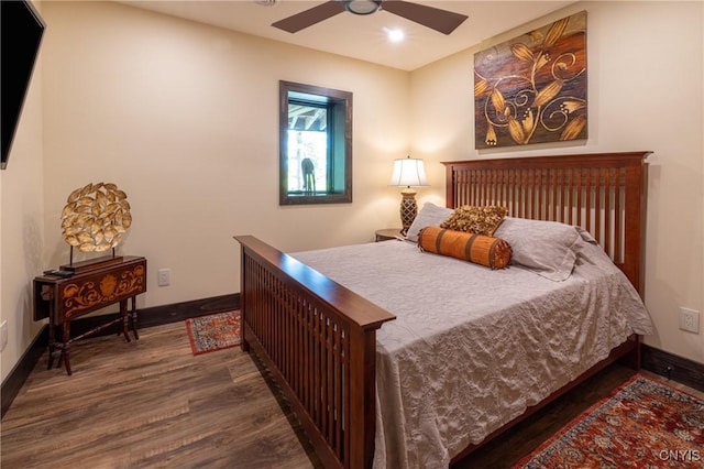 bedroom with a ceiling fan, baseboards, and wood finished floors