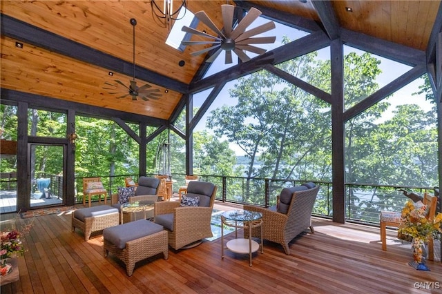 sunroom featuring a ceiling fan, wood ceiling, and plenty of natural light