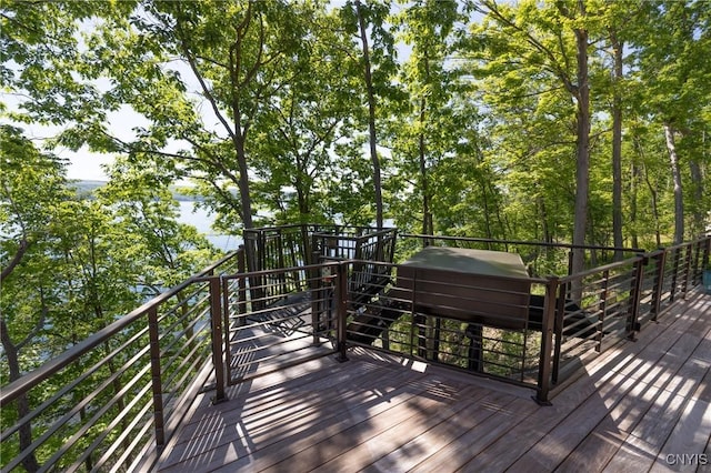 wooden terrace with a water view and grilling area