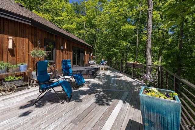 wooden terrace with a covered hot tub