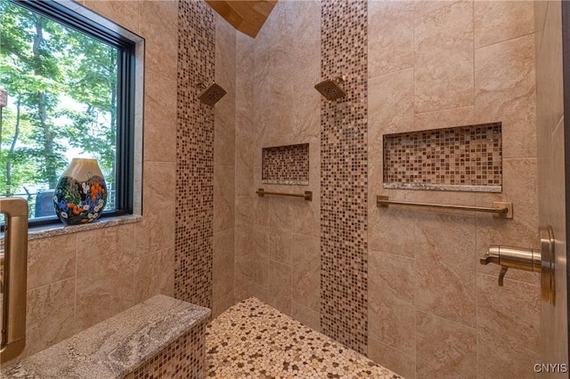 full bath with a tile shower