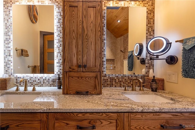 full bath with double vanity, a sink, and decorative backsplash