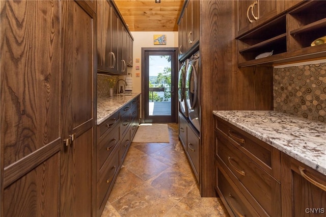 kitchen with light stone counters, wooden ceiling, a sink, and decorative backsplash