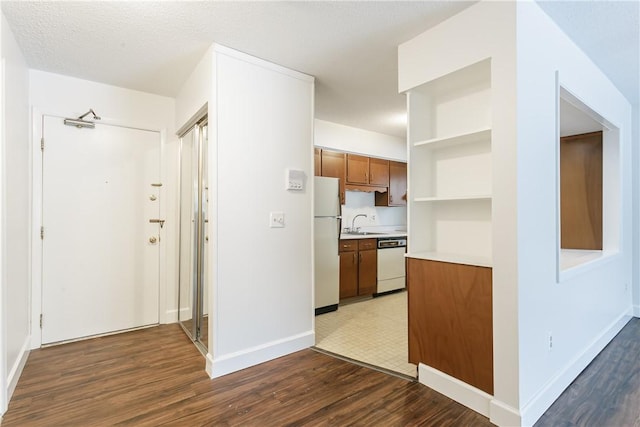 kitchen with dark wood-type flooring, white appliances, light countertops, and open shelves