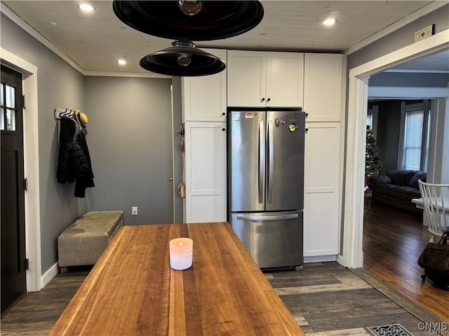 kitchen featuring dark wood finished floors, recessed lighting, freestanding refrigerator, white cabinetry, and wood counters