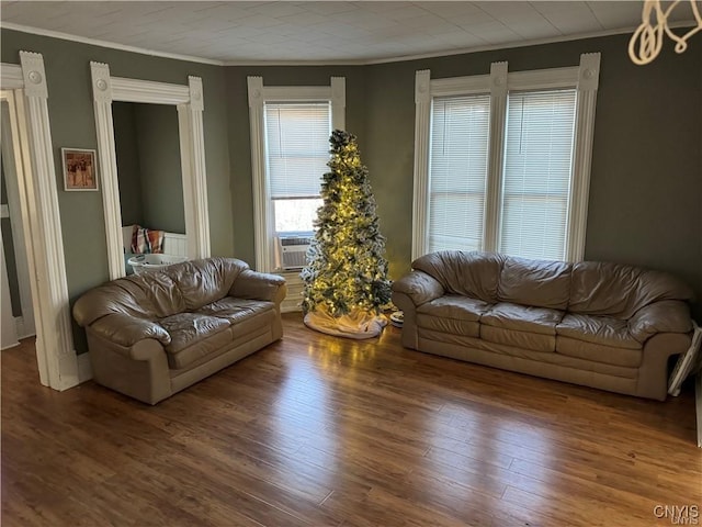 living room featuring crown molding and wood finished floors