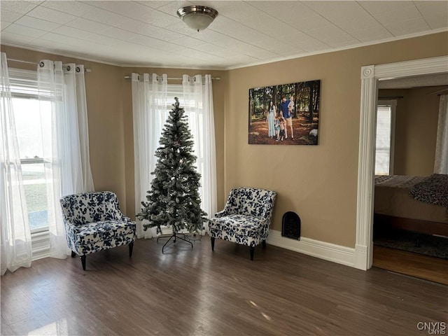 sitting room with plenty of natural light and wood finished floors