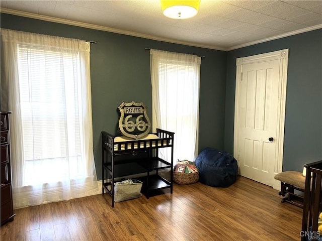 interior space featuring crown molding and wood finished floors