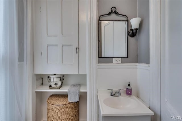 bathroom featuring a wainscoted wall and vanity