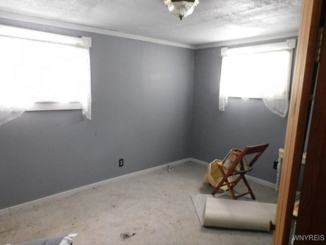 empty room featuring a textured ceiling and baseboards