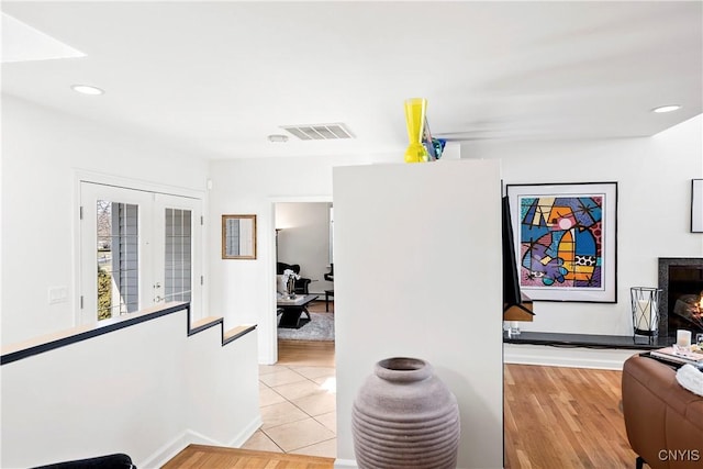 hallway with recessed lighting, french doors, visible vents, and light wood finished floors