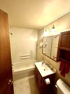 full bath with shower / bath combination, tile patterned flooring, vanity, and toilet