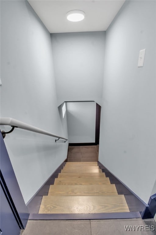 stairway featuring tile patterned flooring